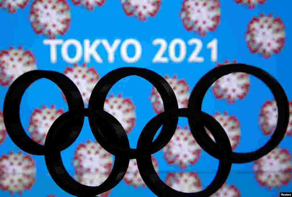 A 3D printed Olympics logo is seen in front of displayed "Tokyo 2021" words in this illustration in Japan.