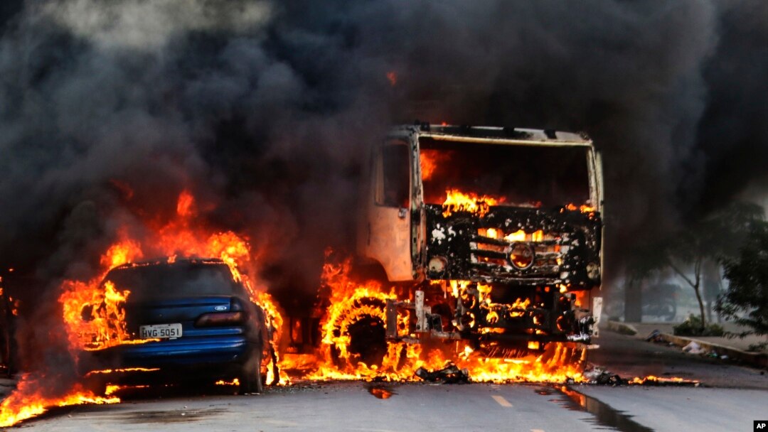 Vehicles burn in the street after attacks in the city of Fortaleza, northeastern Brazil, Jan. 3, 2019. 