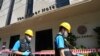 Police forensics team arrive at a hotel in Bangkok, Thailand, Dec. 30, 2024, a day after a fire killed three people. 