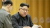 FILE - This image made from undated video of a news bulletin aired by North Korea's KRT on Sept. 3, 2017, North Korea's leader Kim Jong Un holds the Presidium of the Political Bureau of the Central Committee. 