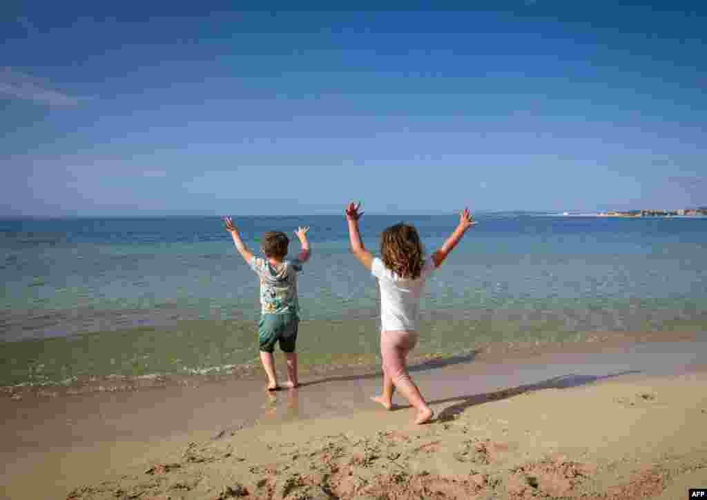 Children play on the Portixol Beach in Palma de Mallorca, Spain. After six weeks stuck at home, children were allowed to go out as the government eased one of the world's toughest coronavirus lockdowns.