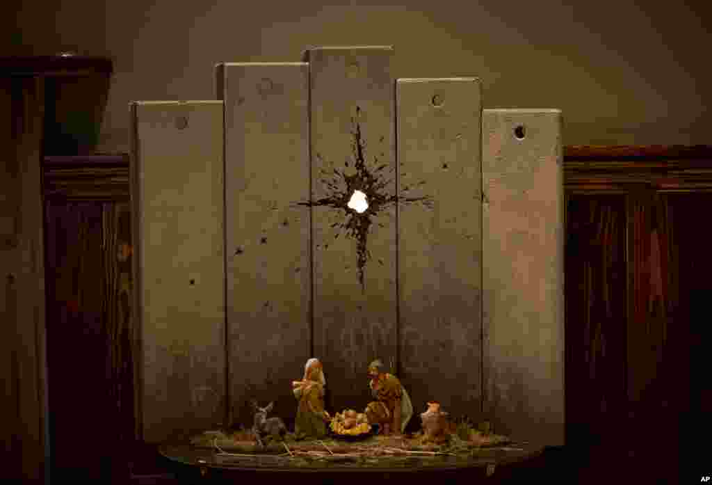A new artwork dubbed "Scar of Bethlehem" by the artist Banksy is displayed in The Walled Off Hotel, in the West Bank city of Bethlehem.