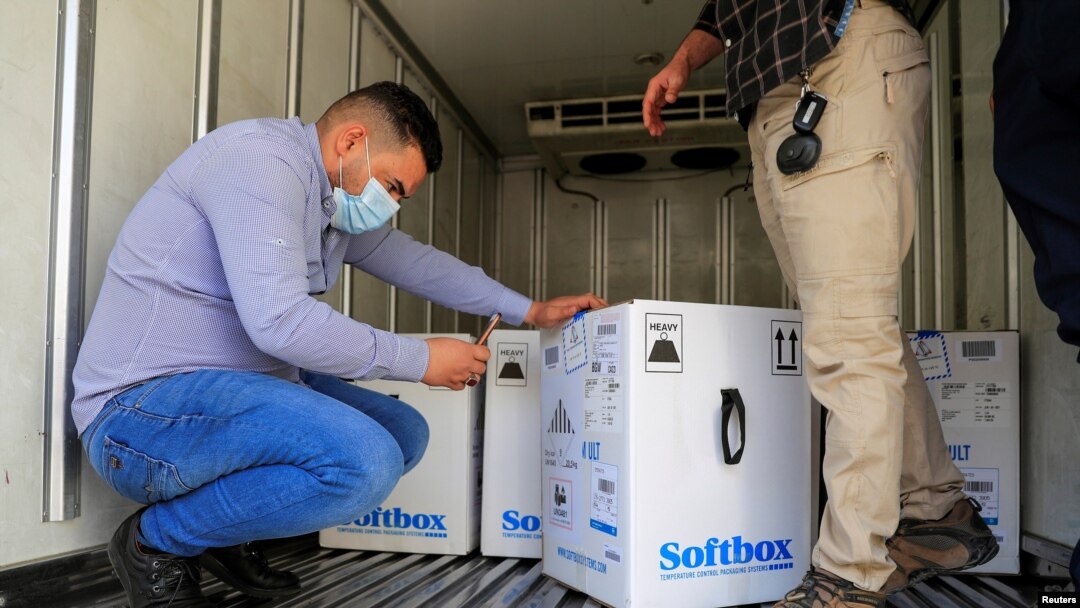 Personnel check the first shipment of the Pfizer's vaccine against the coronavirus disease (COVID-19) at Baghdad International Airport, in Baghdad, Iraq, Apr. 11, 2021. 