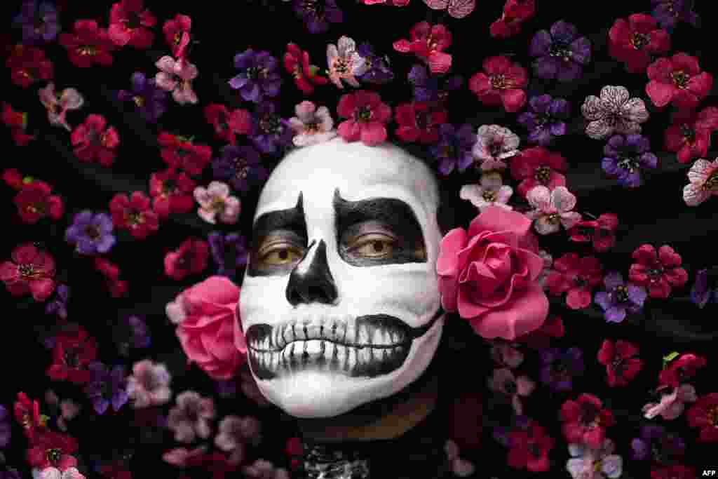 A woman poses for a picture during the KatrinasFest 2024 in San Jose, Costa Rica, Nov. 3, 2024.