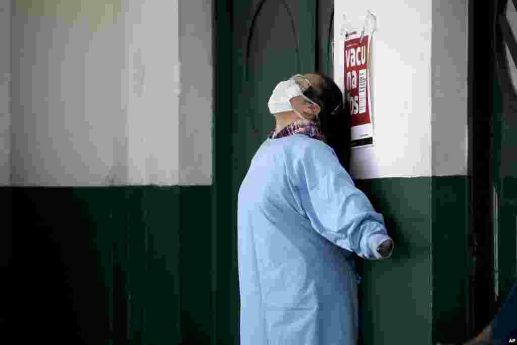 A worker at the Manuel Belgrano public hospital stretches outside the public hospital on the outskirts of Buenos Aires, Argentina.
