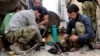 Citizen journalism image provided by Aleppo Media Center AMC which has been authenticated based on its contents and other AP reporting, shows members of the free Syrian Army preparing their weapons, April 25, 2013.