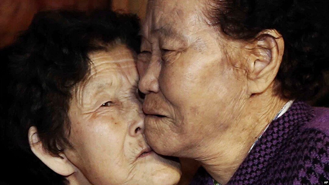 South Korean Lee Chun Hwa, right, gets a kiss from her North Korean sister Lee Chun Son before returning home after a separated family reunion meeting at the Diamond Mountain resort in North Korea, Feb. 22, 2014.