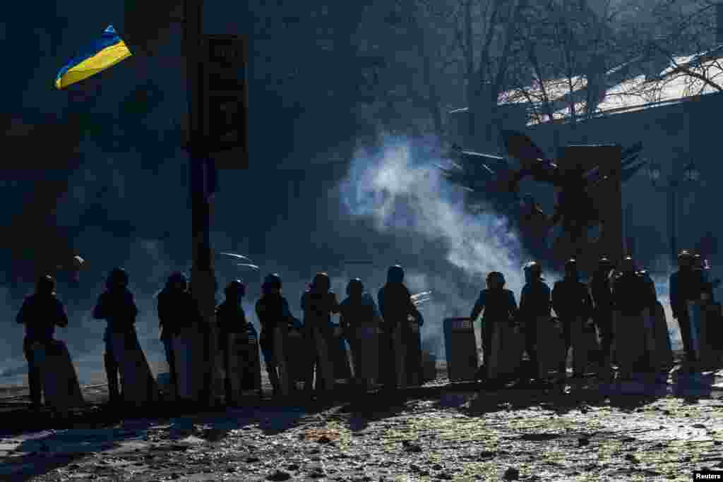 Riot police stand in a cordon facing anti-government protesters as temperatures stand at minus 20 degrees Celsius at a barricade near Independence Square in Kyiv, Jan. 30, 2014.