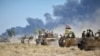 Shiite Popular Mobilization Forces (PMF) and the Iraqi army drive armored vehicles on the outskirts of Hawija, Iraq, Oct. 4, 2017. 