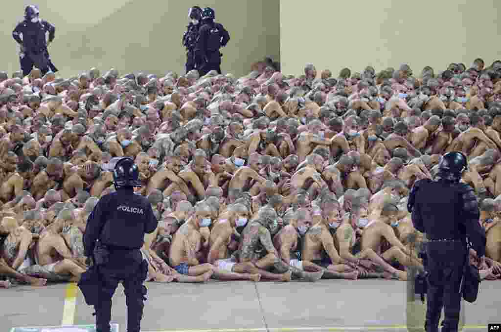 Handout picture released on April 25, 2020 by El Salvador's Presidency press office showing inmates at the Izalco prison, northwest of San Salvador, are seen during a security operation after President Nayib Bukele decreed a maximum emergency in all penitentiary centers housing gang members.
