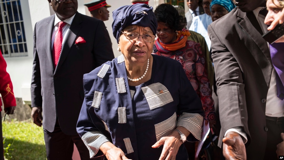 FILE - Sierra Leone President, Ernest Bai Koroma, left, and Liberia President, Ellen Johnson Sirleaf, right, on arrival for talks with President Yahya Jammeh, in Banjul, Gambia.
