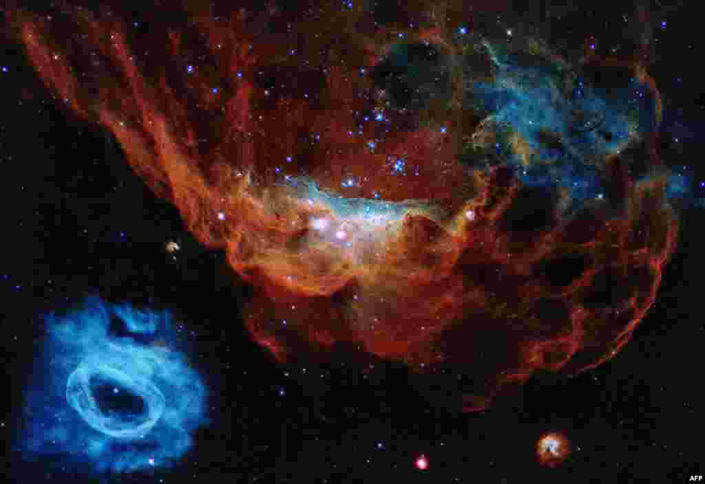 A handout photo made available by the European Space Agency shows one of the most photogenic examples of the many turbulent stellar nurseries the NASA/ESA Hubble Space Telescope has observed during its 30-year lifetime.